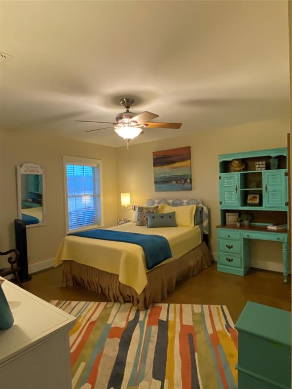 1079 Union Hill Road Mineral Wells, TX 76067 - Photo 33 of 40 a spacious bedroom with a bed and wooden floor