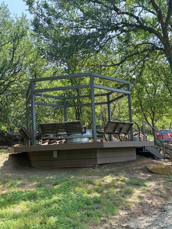 1079 Union Hill Road Mineral Wells, TX 76067 - Photo 10 of 40 a view of a lake with lawn chairs and large trees