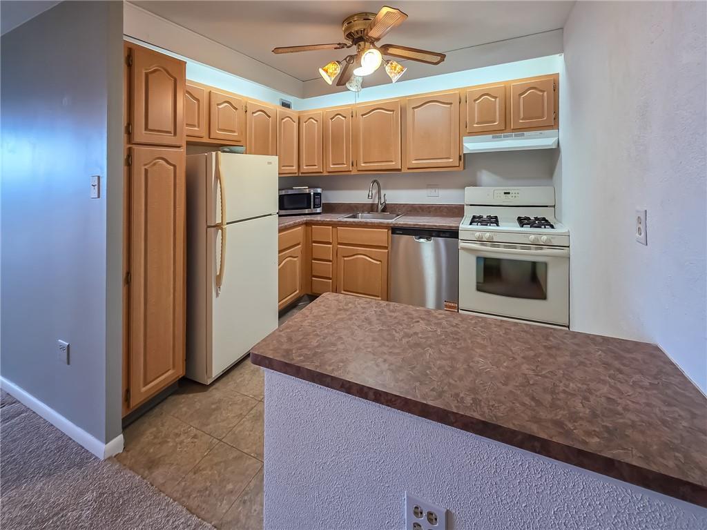 1160 Bower Hill Road, Unit 700C Pittsburgh, PA 15243 - Photo 12 of 35 a kitchen with cabinets stainless steel appliances and a counter top space