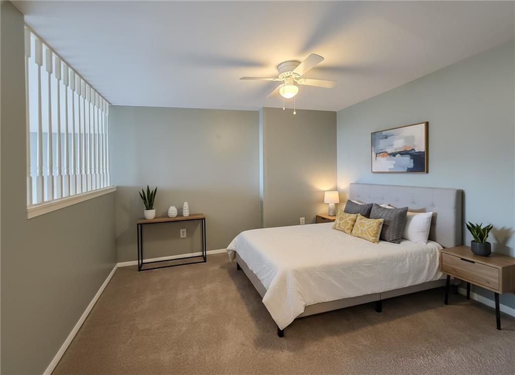 1160 Bower Hill Road, Unit 700C Pittsburgh, PA 15243 - Photo 20 of 35 a bedroom with a bed and a chandelier