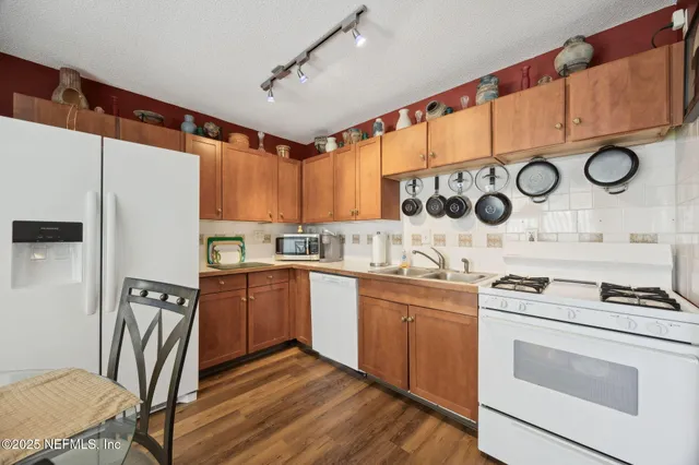 a kitchen with stainless steel appliances kitchen island granite countertop a stove a sink and a refrigerator