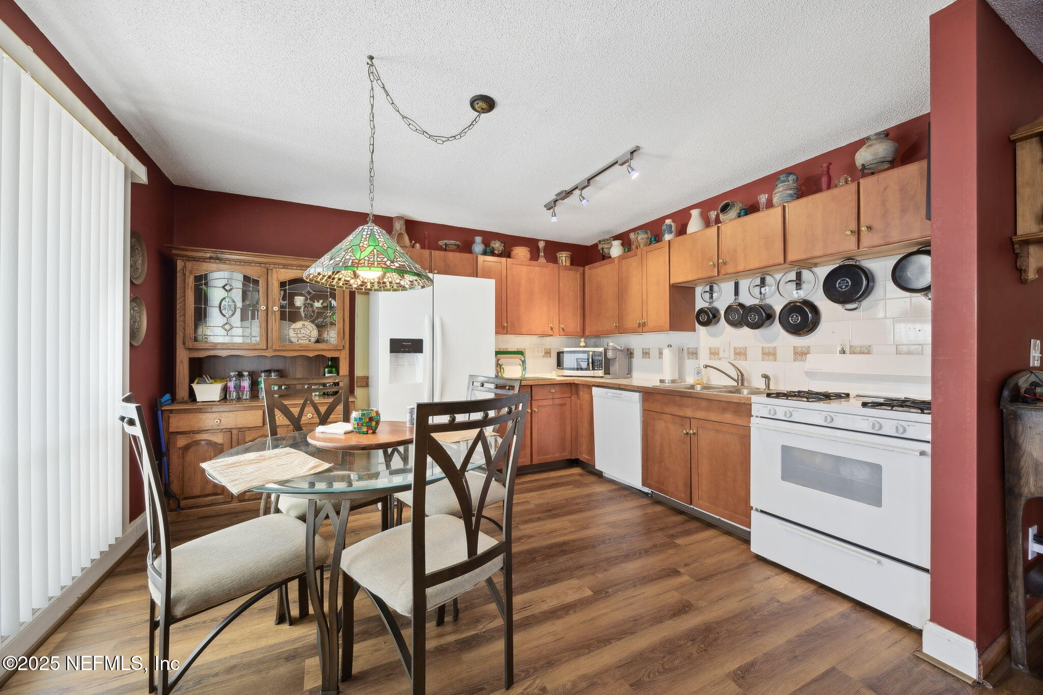 259 South Prospect Street Crescent City, FL 32112 - Photo 12 of 63 a kitchen with stainless steel appliances kitchen island granite countertop a stove a sink and a refrigerator