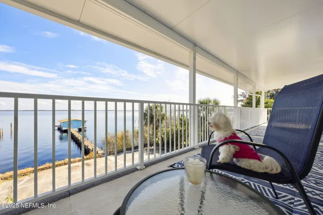 a view of a hallway to a livingroom and a livingroom with furniture