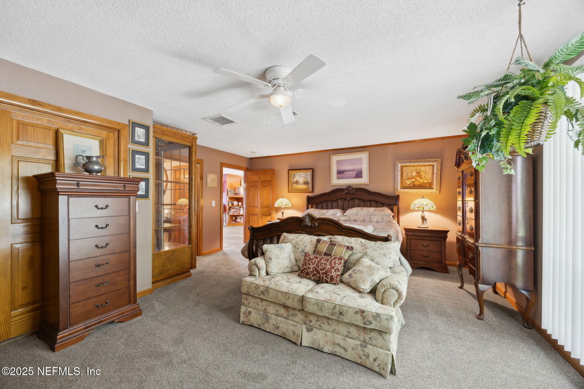 259 South Prospect Street Crescent City, FL 32112 - Photo 19 of 63 a spacious bedroom with a bed dresser and a window