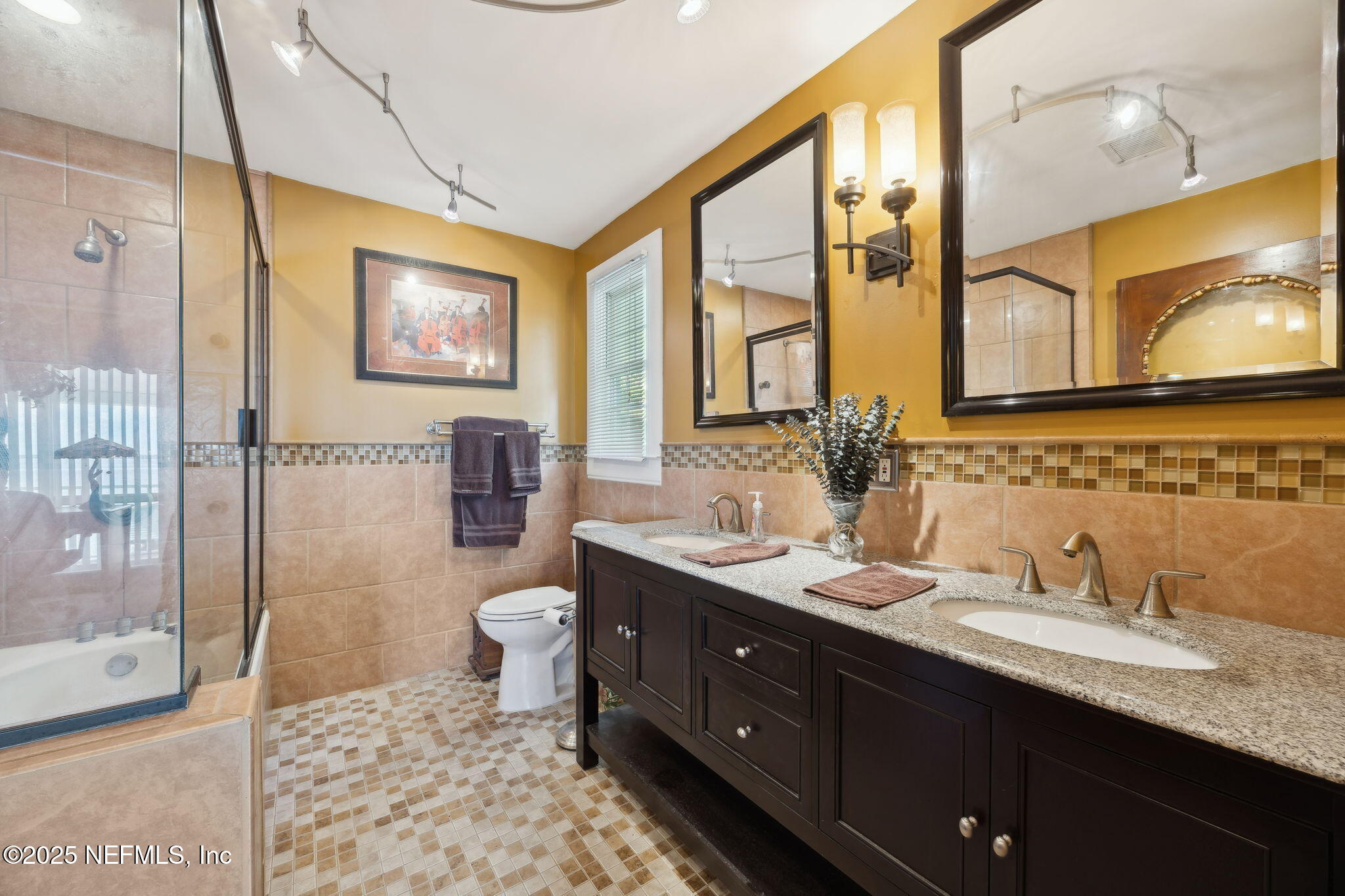 259 South Prospect Street Crescent City, FL 32112 - Photo 26 of 63 a bathroom with a double vanity sink toilet mirror and shower