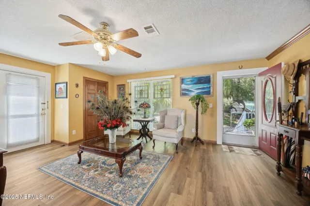 a living room with furniture and a ceiling fan