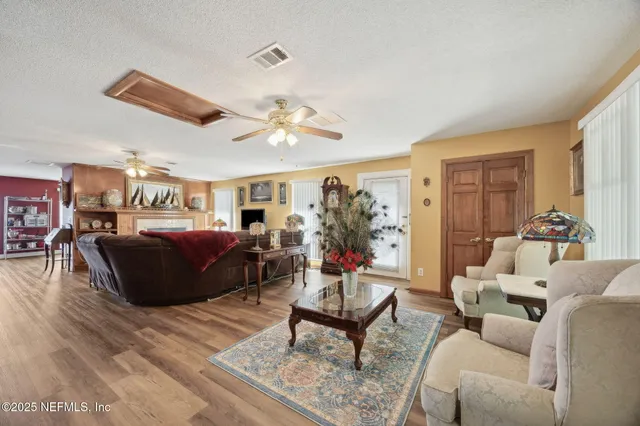a living room with furniture a fireplace and a flat screen tv