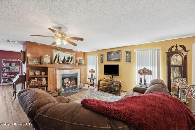 a living room with furniture a fireplace and a flat screen tv