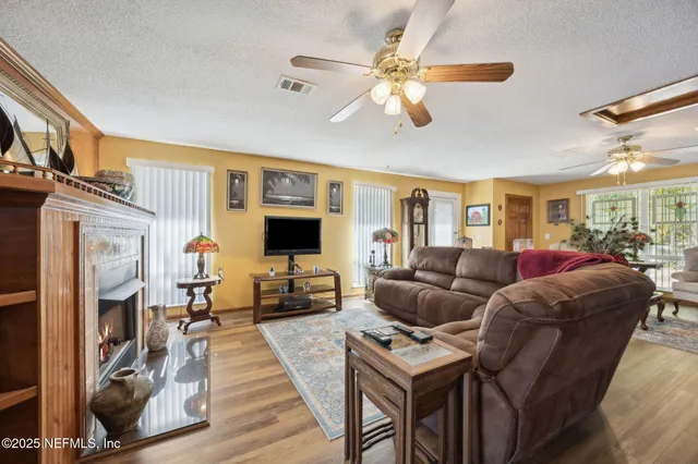 a living room with furniture a flat screen tv and a fireplace