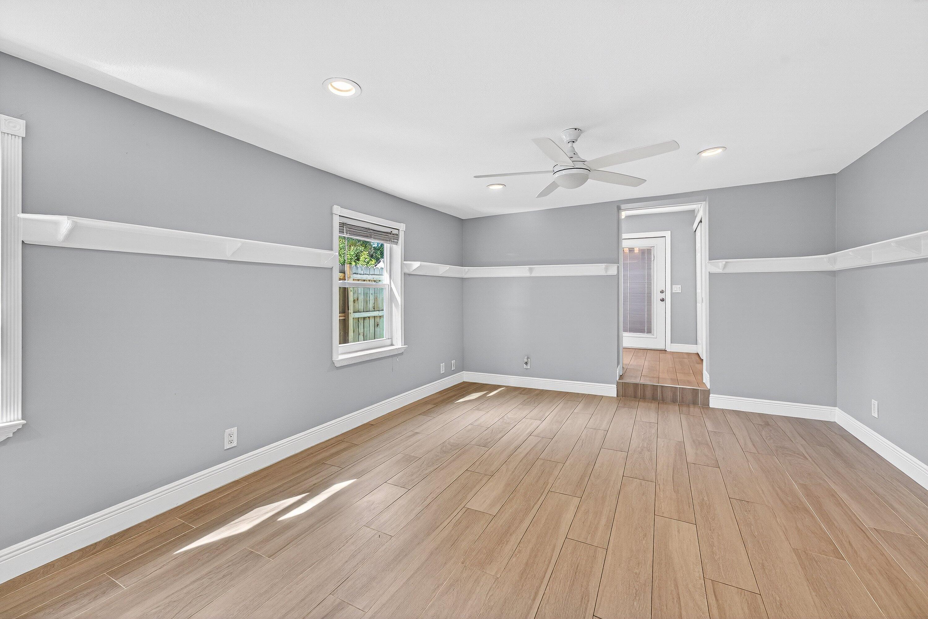 5565 Papaya Road Royal Palm Estates, FL 33413 - Photo 14 of 30 wooden floor in an empty room with a window