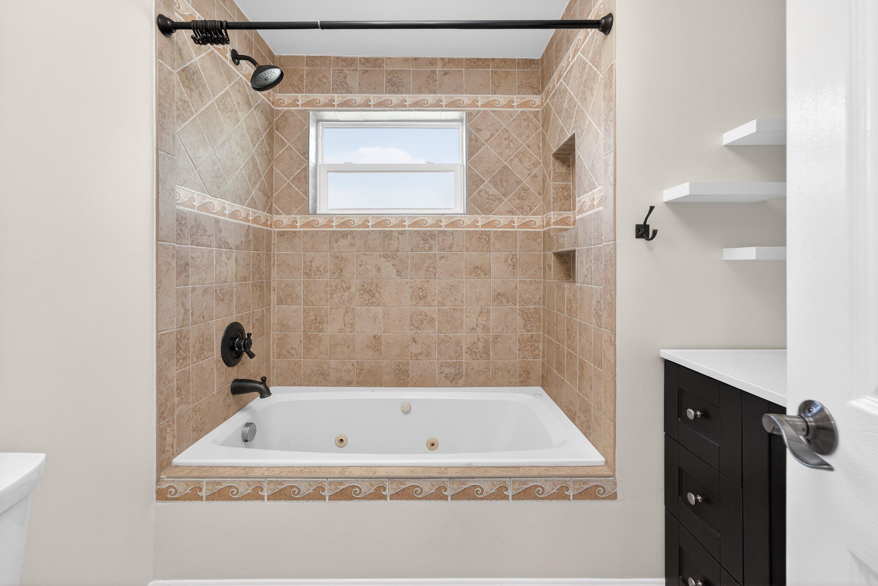 5565 Papaya Road Royal Palm Estates, FL 33413 - Photo 23 of 30 a bathroom with a tub