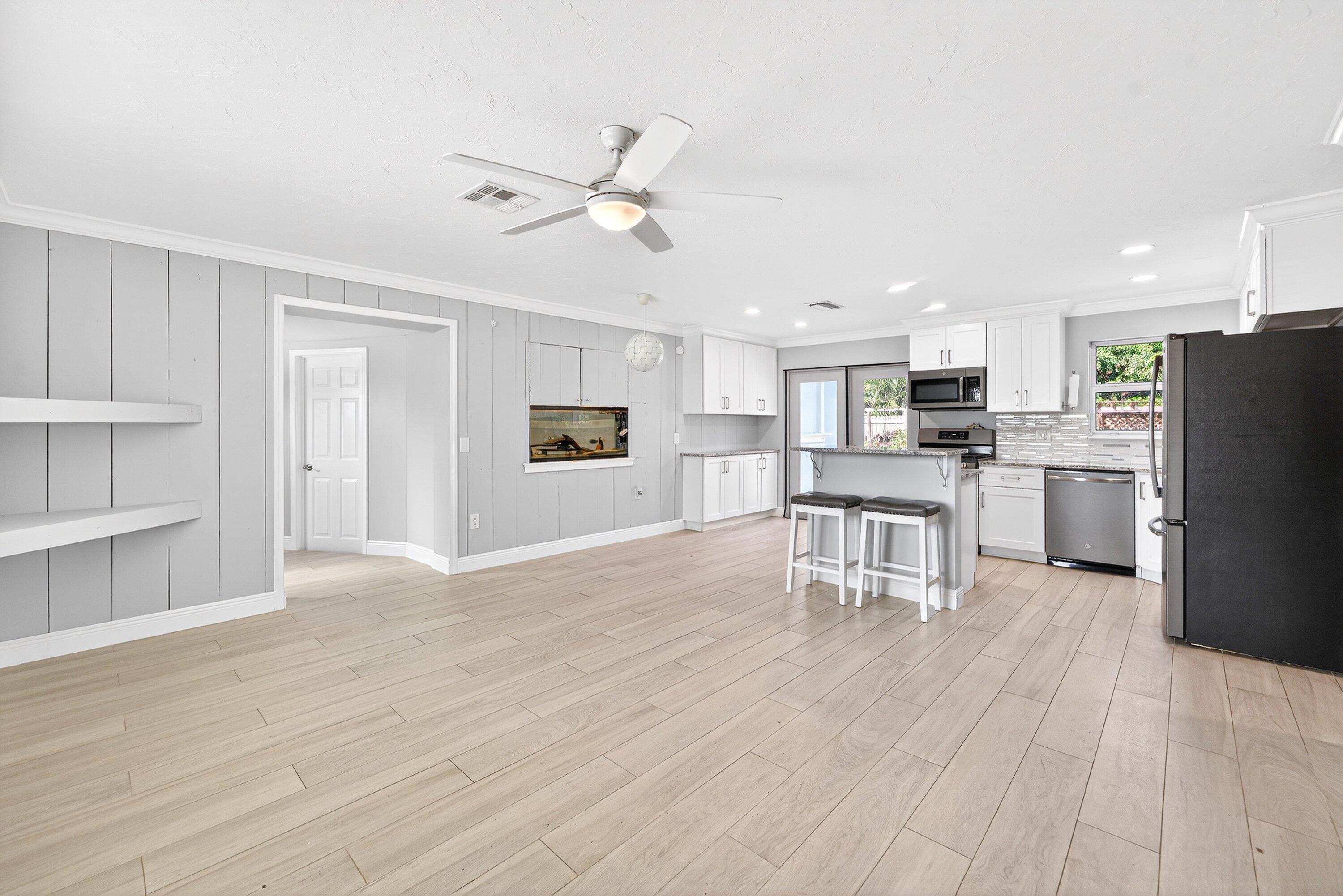 5565 Papaya Road Royal Palm Estates, FL 33413 - Photo 6 of 30 a view of kitchen with refrigerator microwave and cabinets