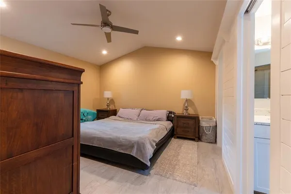 a bedroom with a bed and a chandelier