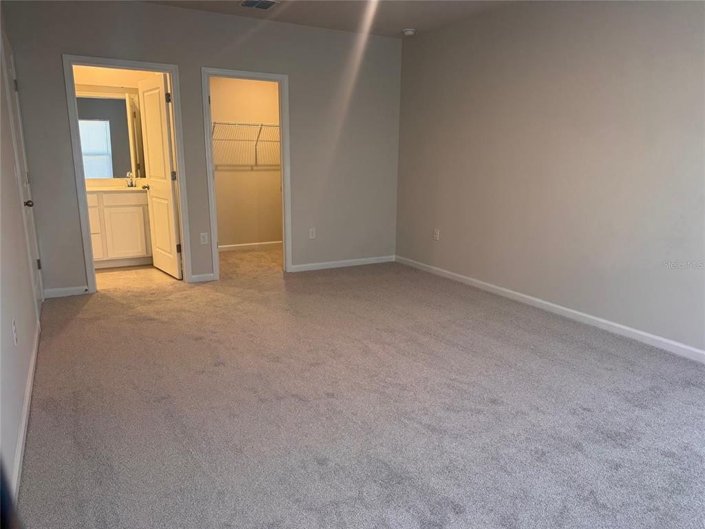 347 Biltmore Boulevard Dundee, FL 33838 - Photo 6 of 18 an empty room with windows and entrance to other room