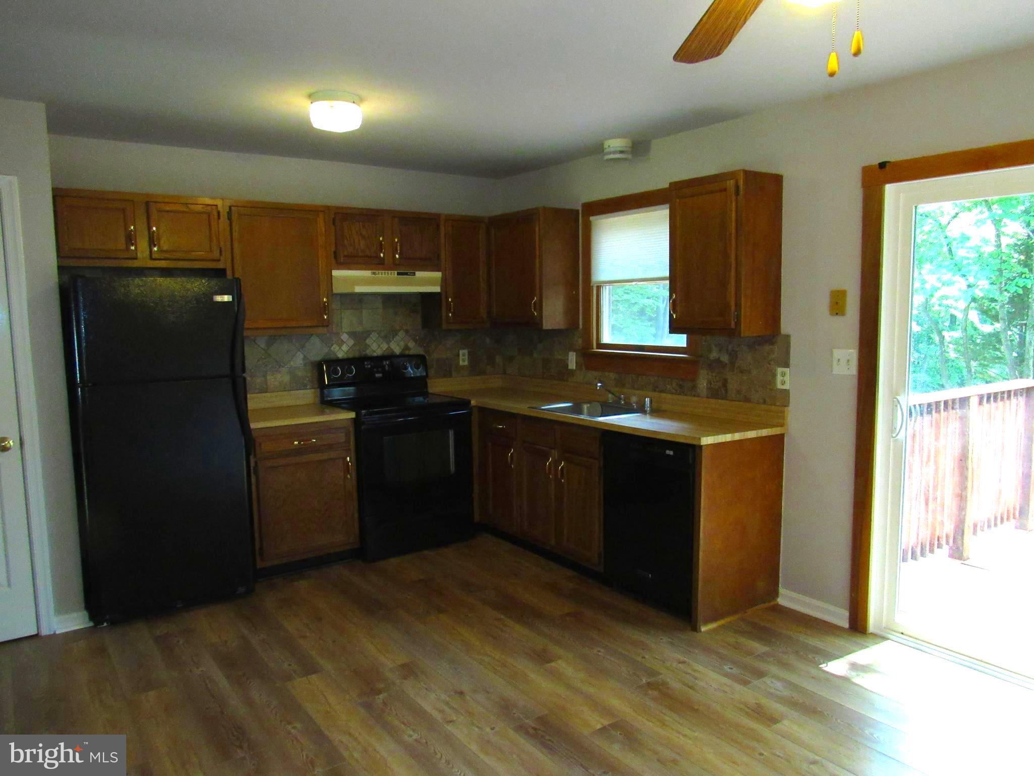 3235 Richfield Road Huntingtown, MD 20639 - Photo 25 of 64 a kitchen with granite countertop a refrigerator and a sink