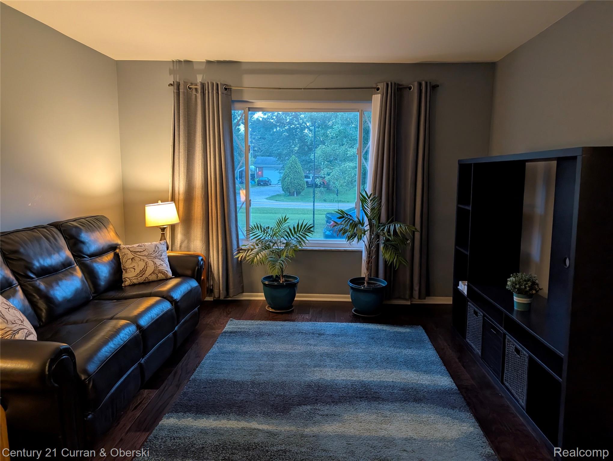 9371 Bennett Lake Road Fenton, MI 48430 - Photo 12 of 17 Hardwood-finish flooring, neutral wall paint, and a window with curtain rods