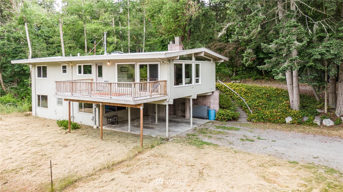 21429 Monument Road Southwest Vashon, WA 98070 - Photo 2 of 37 a view of a house with a backyard