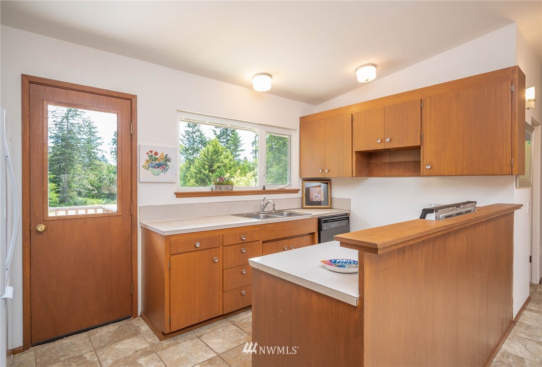21429 Monument Road Southwest Vashon, WA 98070 - Photo 22 of 37 a view of a kitchen with a sink cabinets and a window