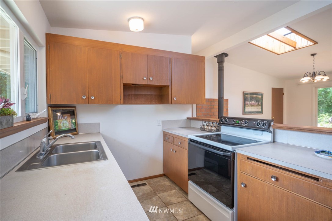 21429 Monument Road Southwest Vashon, WA 98070 - Photo 23 of 37 a kitchen that has a sink and a stove in it