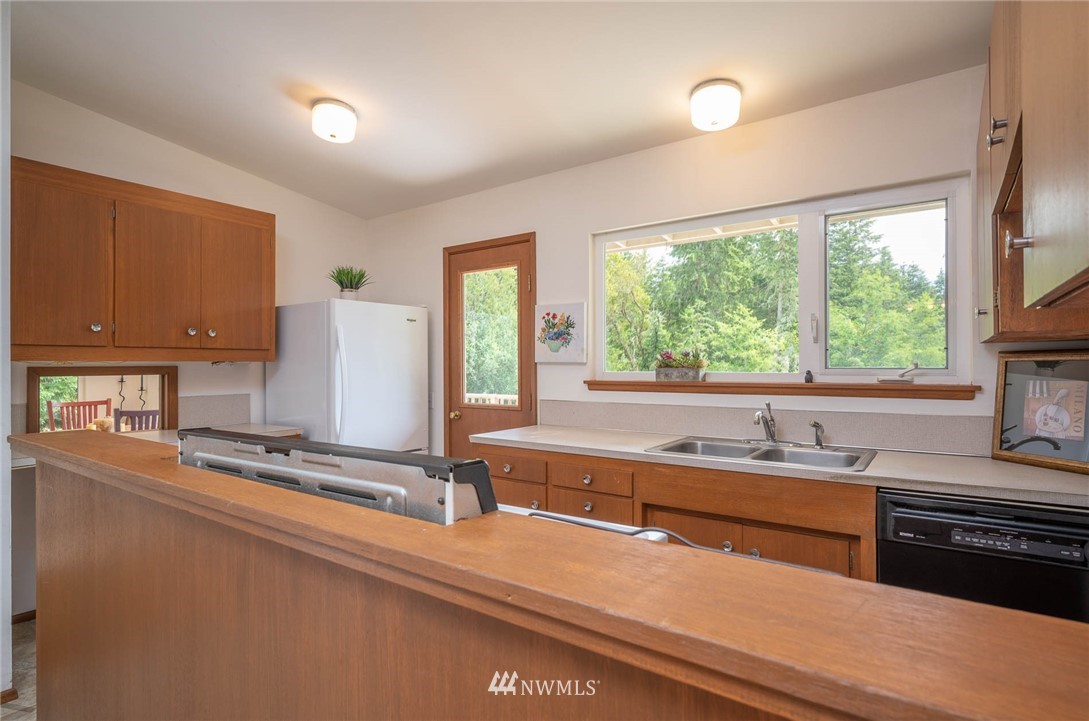 21429 Monument Road Southwest Vashon, WA 98070 - Photo 24 of 37 a kitchen with a sink and a large window