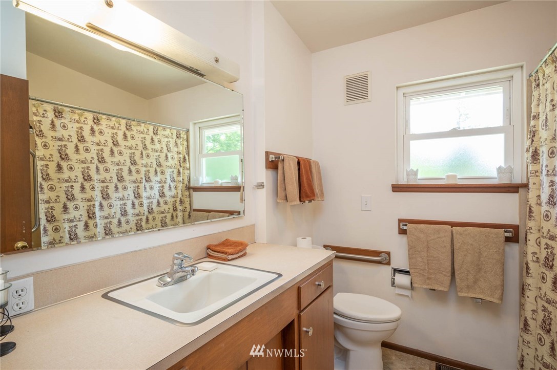 21429 Monument Road Southwest Vashon, WA 98070 - Photo 28 of 37 a bathroom with a sink toilet and mirror