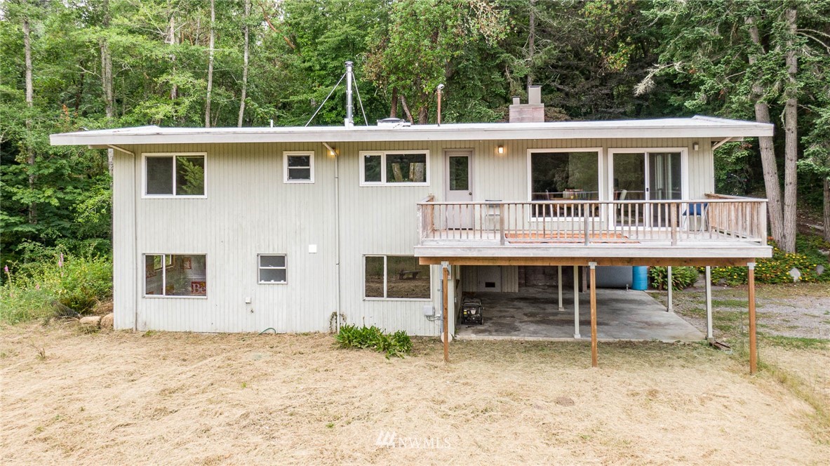 21429 Monument Road Southwest Vashon, WA 98070 - Photo 29 of 37 a view of a house with a yard and sitting area