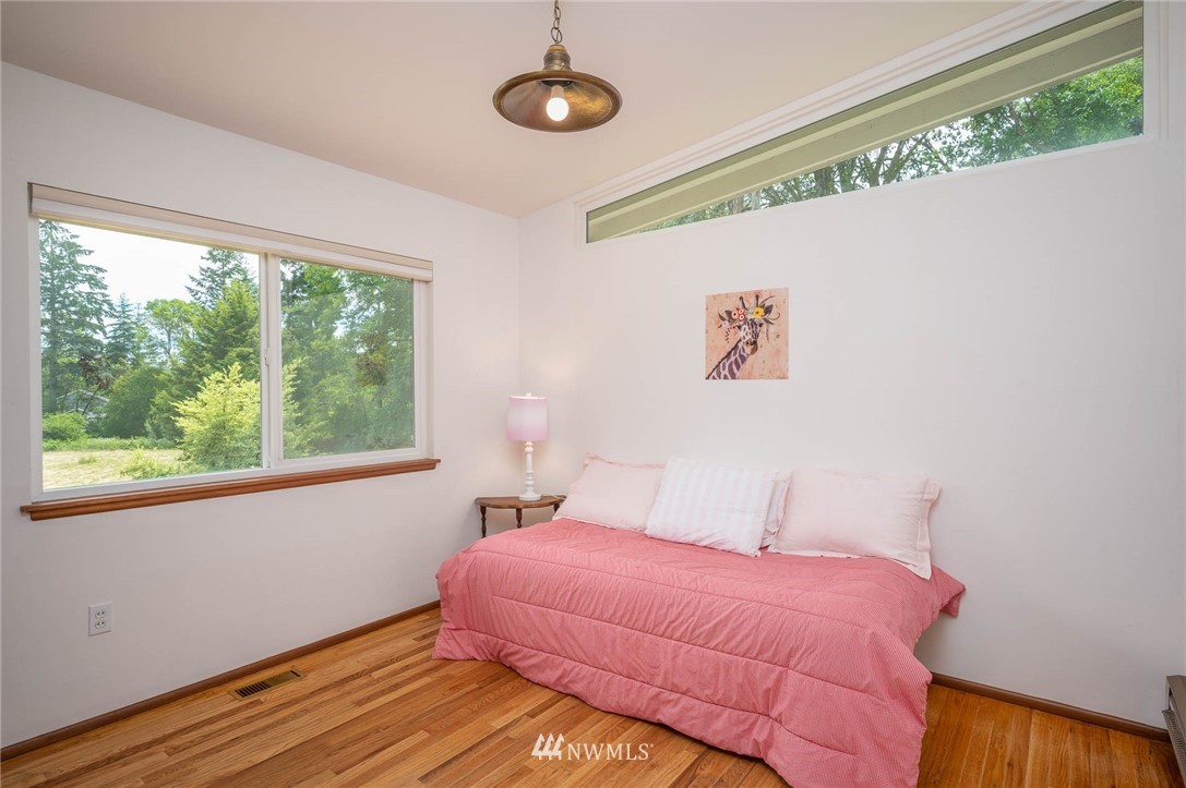 21429 Monument Road Southwest Vashon, WA 98070 - Photo 30 of 37 a bedroom with a bed and a window