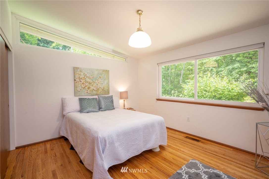 21429 Monument Road Southwest Vashon, WA 98070 - Photo 31 of 37 a bedroom with a bed and a window