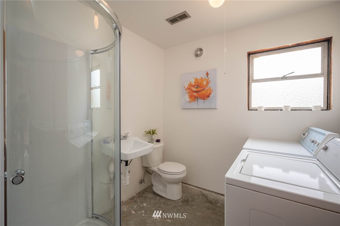 21429 Monument Road Southwest Vashon, WA 98070 - Photo 34 of 37 a bathroom with a toilet and a shower curtain