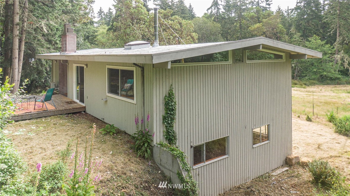 21429 Monument Road Southwest Vashon, WA 98070 - Photo 7 of 37 a front view of a house with garden