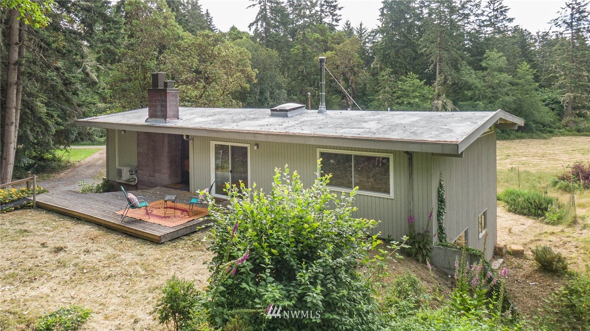 21429 Monument Road Southwest Vashon, WA 98070 - Photo 8 of 37 a view of a house with a yard plants and large tree