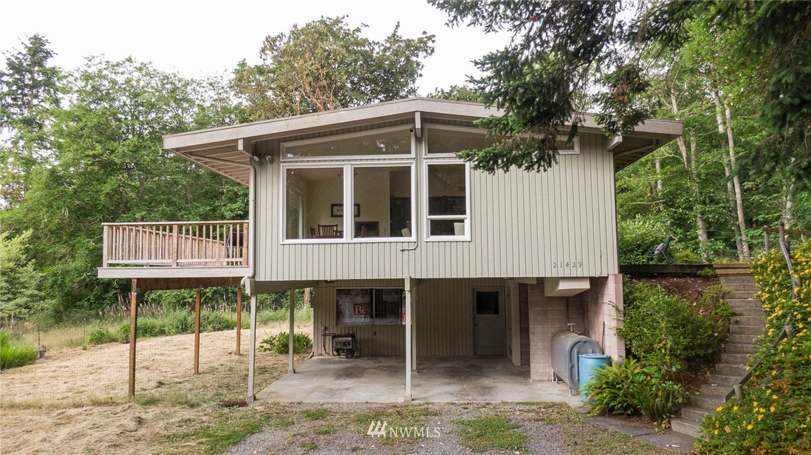 21429 Monument Road Southwest Vashon, WA 98070 - Photo 10 of 37 a front view of a house with a yard