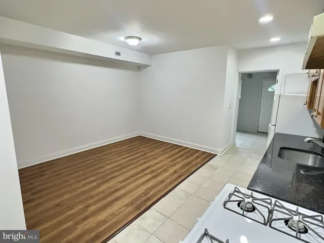 a view of a room with wooden floor