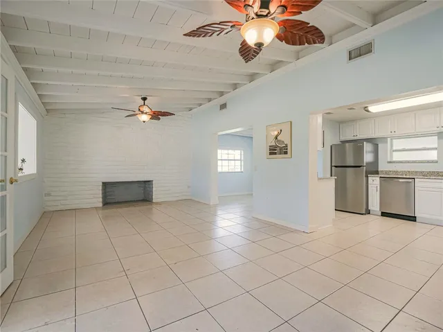 a kitchen with a refrigerator sink and cabinets