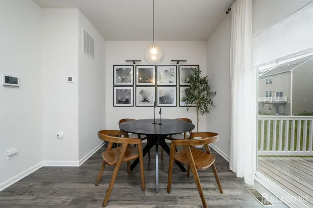 a view of a dining room with furniture and chandelier