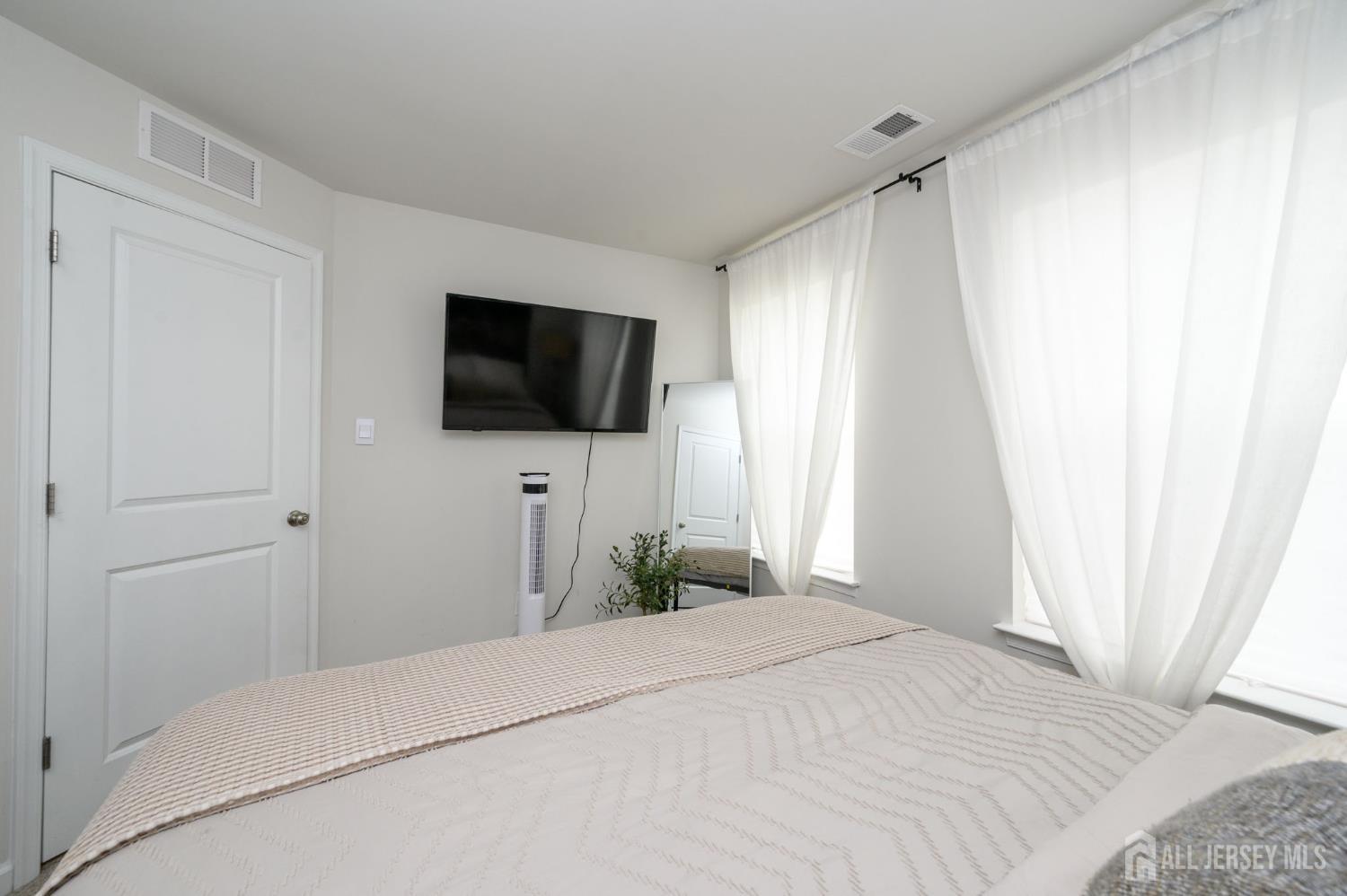 7 Foundry Blvd Mount Mount Holly, NJ 08060 - Photo 23 of 42 a bedroom with a bed and a flat screen tv