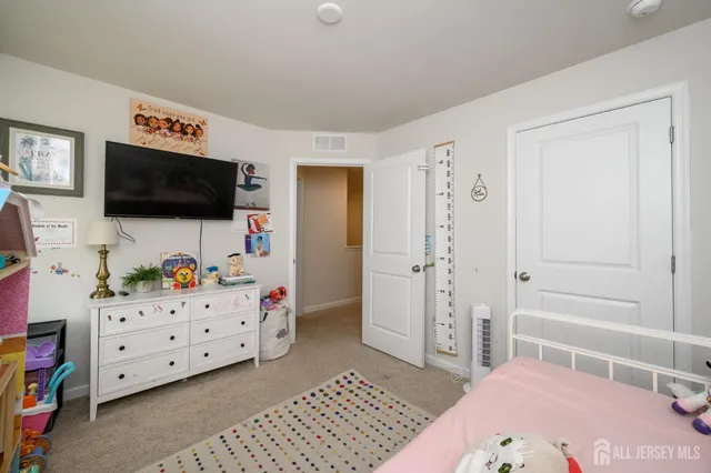 a bedroom with a bed and flat screen tv