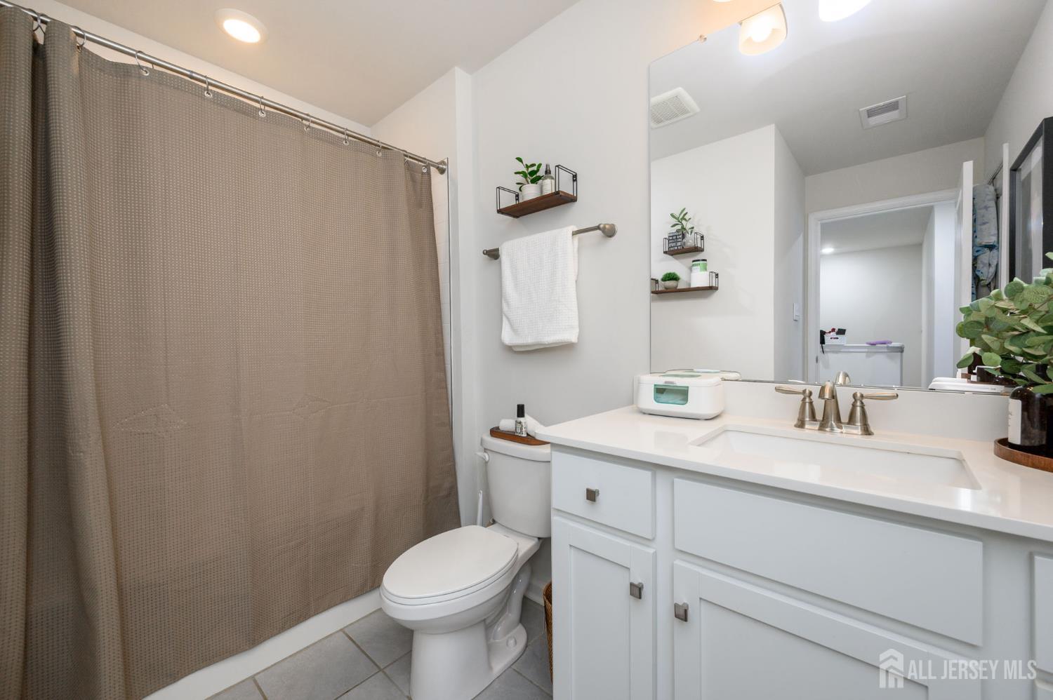 7 Foundry Blvd Mount Mount Holly, NJ 08060 - Photo 29 of 42 a bathroom with a granite countertop sink a toilet and mirror