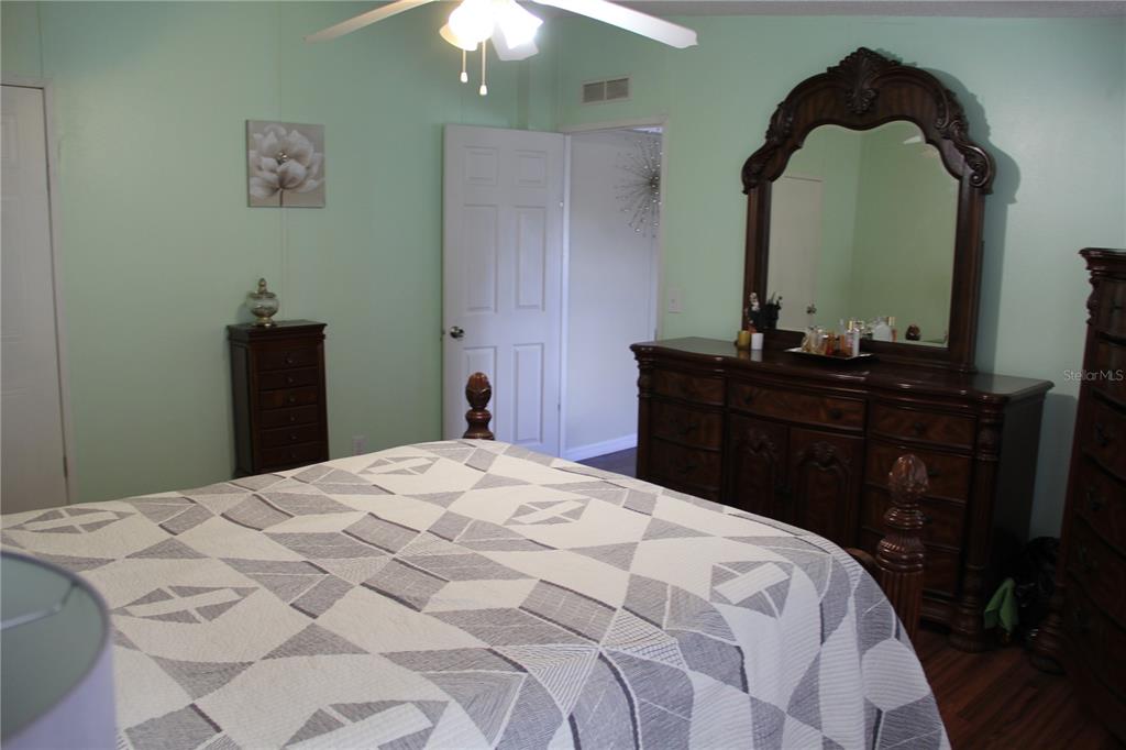 13127 Star Road Brooksville, FL 34613 - Photo 20 of 54 a bedroom with a bed and a dresser