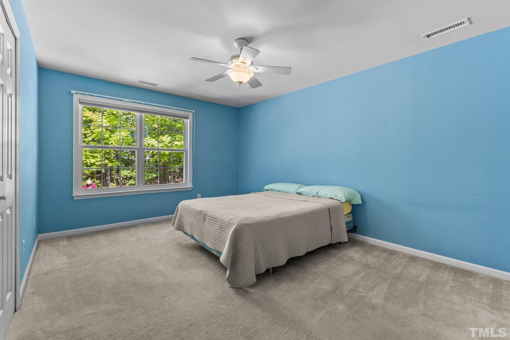 10507 Dapping Drive Raleigh, NC 27614 - Photo 30 of 38 a spacious bedroom with a bed and a window
