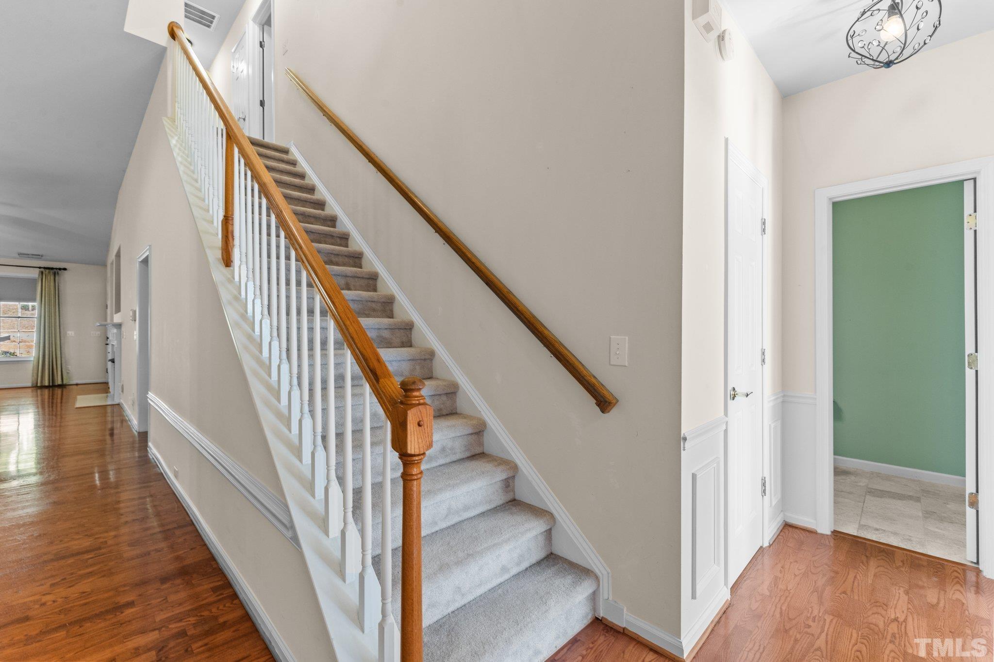 10507 Dapping Drive Raleigh, NC 27614 - Photo 4 of 38 a view of a hallway with wooden floor and staircase