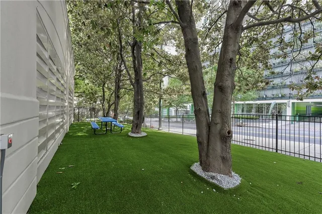 a view of a backyard with large trees