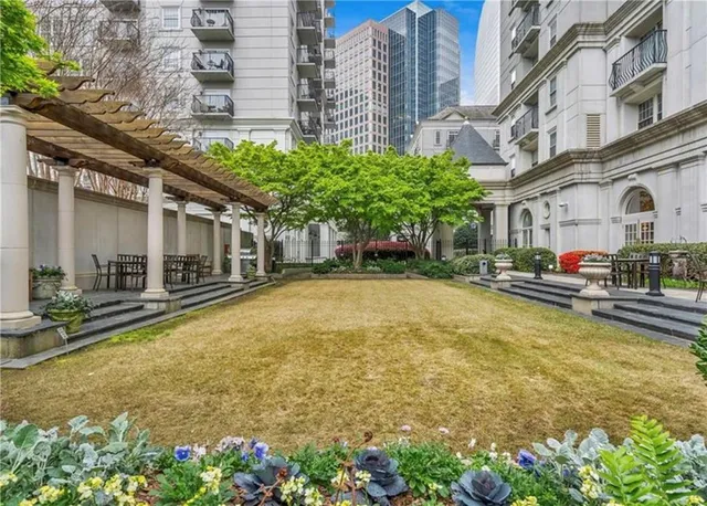 a swimming pool with outdoor seating and yard
