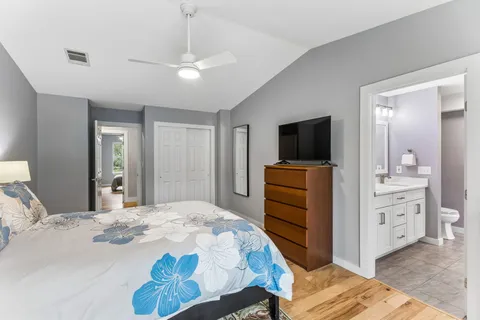 a bedroom with a bed and a flat screen tv