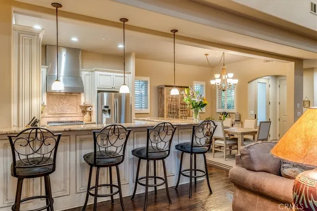a kitchen with granite countertop a sink stainless steel appliances and cabinets