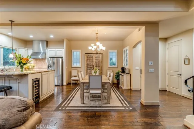 a spacious bedroom with a bed and a chandelier