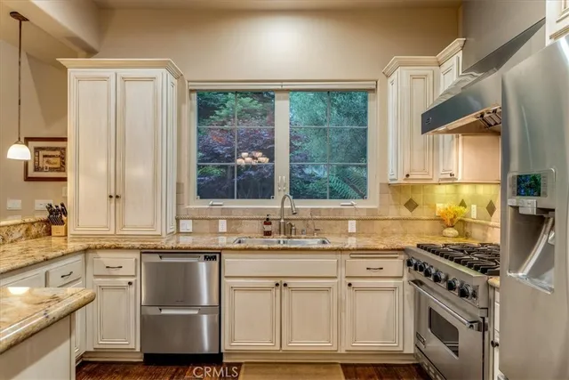 a spacious bedroom with a bed and a chandelier