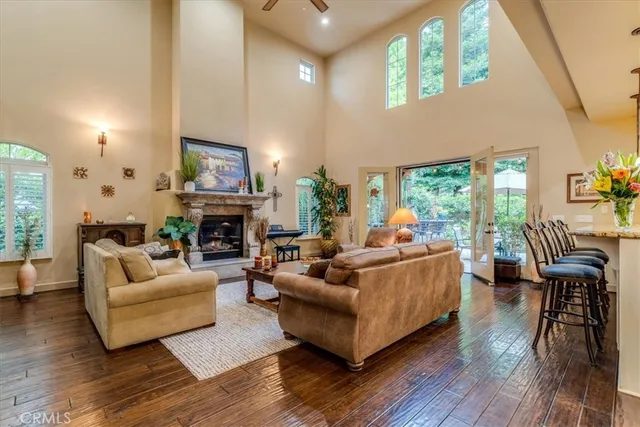 a living room with fireplace furniture and a wooden floor