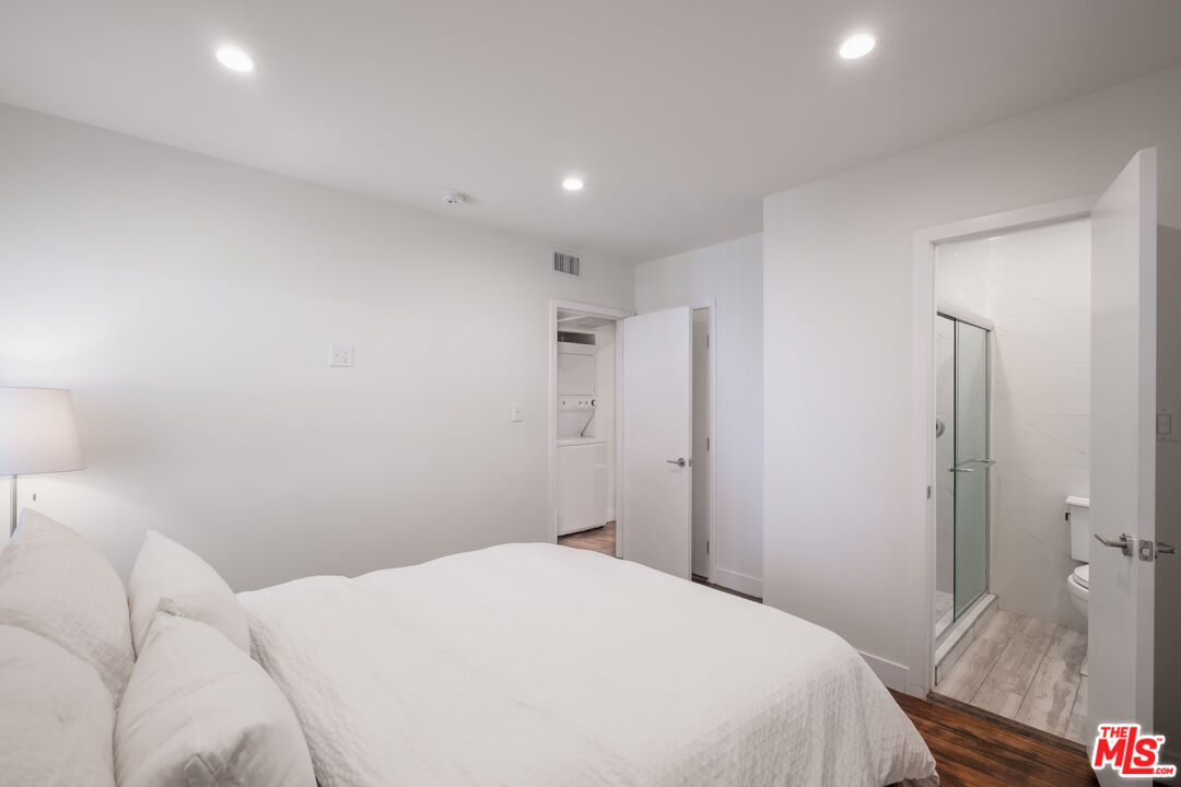 1024 Maple Street, Unit 1 Santa Monica, CA 90405 - Photo 11 of 16 a bedroom with a bed and a chandelier