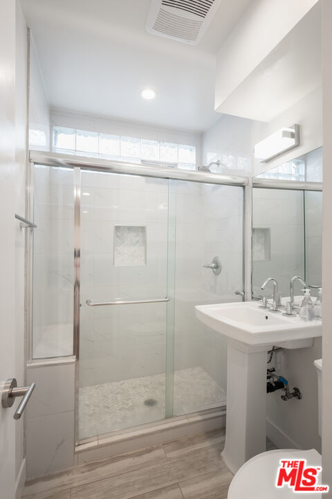 1024 Maple Street, Unit 1 Santa Monica, CA 90405 - Photo 14 of 16 a bathroom with a sink mirror and shower